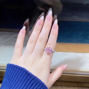 Macro shot of S925 silver ring with pink cushion-cut stone and side diamonds