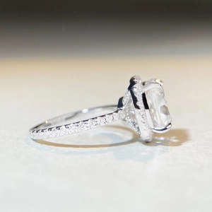 Detailed side view of 5 carat radiant cut moissanite ring with halo and pave band