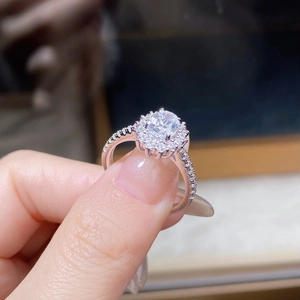 Macro shot of oval cut moissanite ring with halo setting on S925 sterling silver band