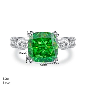 Macro view of 10x10mm cushion cut green zircon set in 925 silver crossover ring