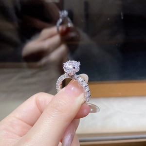 Macro detail of 3-carat moissanite ring showing brilliant round cut and pavé diamonds