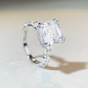 Macro side view of 5-carat Asscher cut moissanite ring with twisted pavé silver band