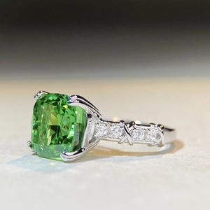 925 silver ring featuring a large cushion-cut emerald zircon and crisscross diamond band