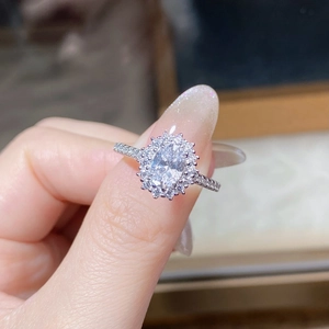 Macro shot of 1 carat oval cut moissanite ring with halo setting on S925 silver band