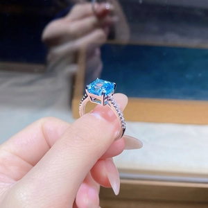 Macro shot of S925 sterling silver ring with square blue zircon and pavé-set side stones