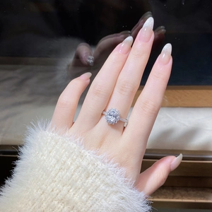 Close-up of elegant S925 silver ring featuring a 1-carat oval moissanite and halo stones