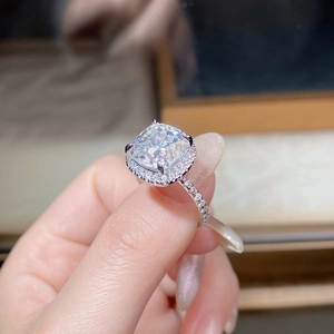 Macro shot of 5-carat cushion-cut moissanite ring with halo setting on sterling silver