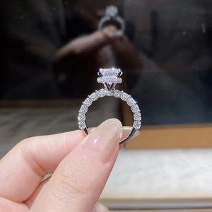Macro detail of 3-carat moissanite ring with six-prong setting and pavé diamond halo