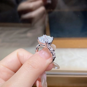 Macro detail of a 5 carat Asscher cut moissanite ring with S925 silver pavé band setting