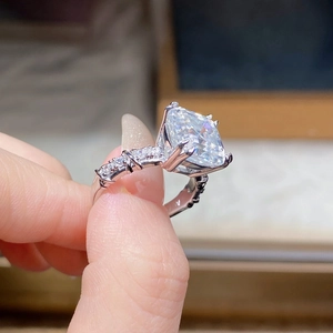 Macro view of Asscher cut moissanite ring with S925 silver setting and pavé accents