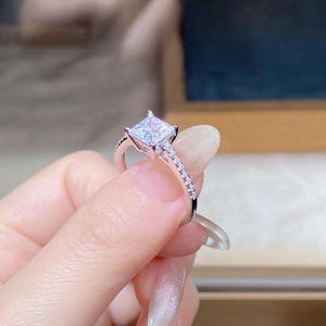 Macro detail of princess cut moissanite ring in 925 sterling silver with micro-pave diamonds