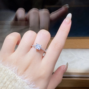 On-hand view of a 925 silver princess cut moissanite ring with side accent diamonds