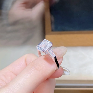 Detailed close-up of S925 sterling silver hallmark on emerald-cut moissanite ring band