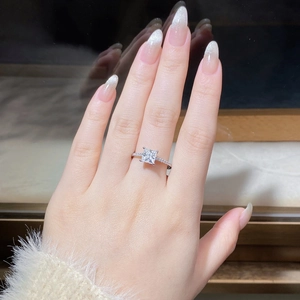 Detail of princess cut moissanite ring in 925 silver with side micro-pave diamonds