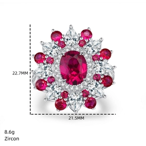 Detailed view of luxury flower ring with large red gemstone and zircon accents