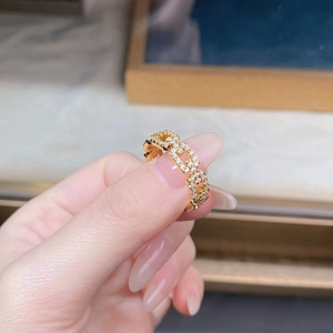 Close-up of a gold-plated link ring featuring sparkling pavé cubic zirconia diamonds