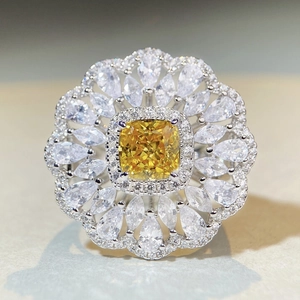 Luxurious 925 silver ring featuring a central yellow diamond and floral zircon halo