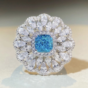 Floral S925 silver ring featuring blue cushion-cut zircon and white crystal petals