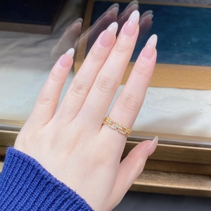 Close-up of a gold chain ring with sparkling cubic zirconia on a model hand