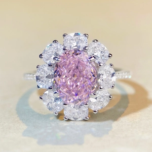 Macro shot of a flower-shaped ring with a large pink oval gem and a halo of diamonds