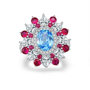 Floral 925 silver cocktail ring with oval blue gemstone and red stone accents