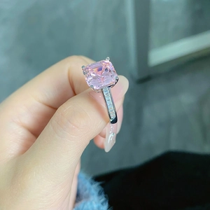 Detail of an Asscher cut pink sapphire ring in S925 silver with baguette side stones