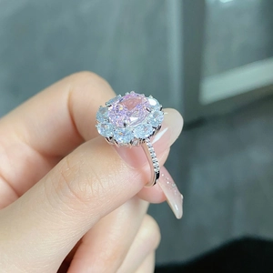 Macro view of S925 silver ring featuring radiant cut pink gemstone with halo setting