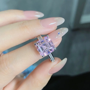 Macro shot of Asscher cut pink sapphire ring with side baguette stones on S925 silver band