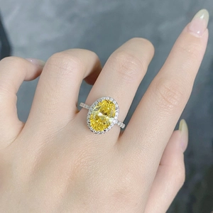 Macro detail of oval cut yellow gemstone ring with halo diamonds on S925 silver band