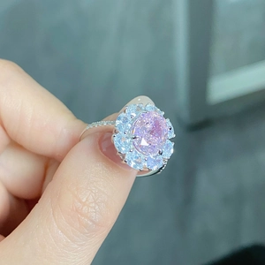 Detailed close-up of radiant cut pink zircon ring with floral halo in S925 sterling silver