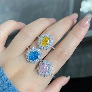 Detailed view of luxury floral rings with yellow, blue, and pink oval center stones