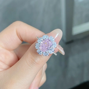Close-up of S925 silver ring featuring an oval pink gemstone in a floral halo setting