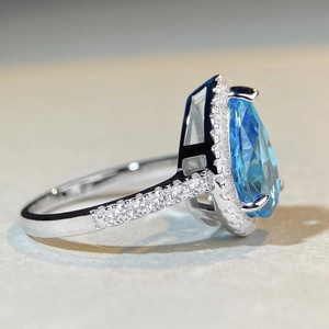 Elegant S925 silver halo ring featuring a pear-cut blue gemstone with zircon micro-pave