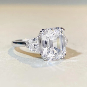 Luxurious S925 silver emerald cut cubic zirconia ring with three-stone side settings
