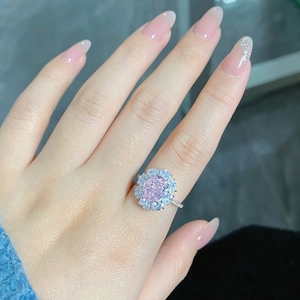 Close-up of radiant cut pink gemstone ring with halo diamonds on S925 silver band