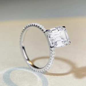 925 silver ring featuring a 4-carat emerald cut cubic zirconia with pave setting accents