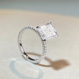 Elegant emerald cut moissanite engagement ring with pavé set band in S925 sterling silver