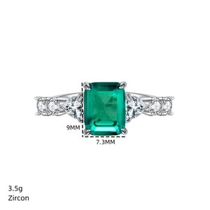 Detailed macro view of 9mm x 7.3mm emerald-cut green zircon ring with silver metal band
