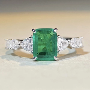 Elegant S925 silver ring featuring emerald cut green gemstone with pear shaped side stones