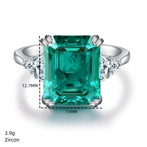 Macro shot of 925 silver ring featuring emerald-cut green zircon and triangular side stones