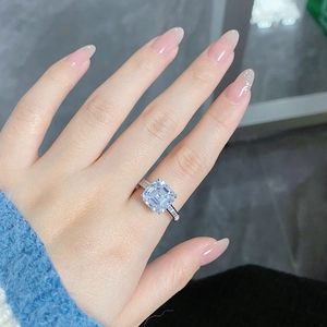 Close-up of a silver S925 ring with a large square diamond and pavé set band