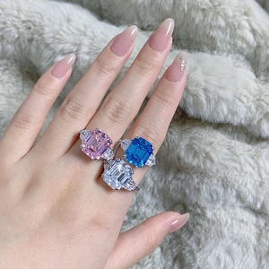 Detailed view of emerald cut rings in pink, blue, and clear zircon with 925 silver finish