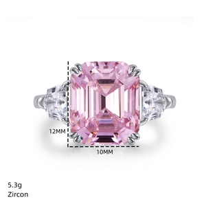 Macro shot of 12x10mm emerald cut pink zircon ring with three-stone silver setting