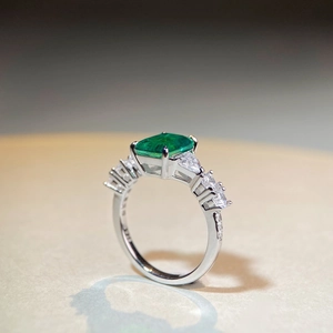 Macro shot of S925 sterling silver stamp and emerald green stone with zircon accents