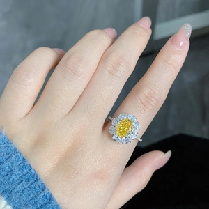 Close-up of S925 silver ring featuring a yellow floral diamond cluster on a model hand