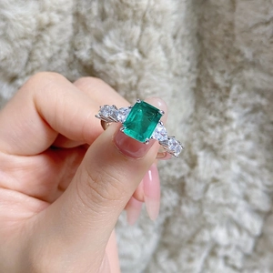 Detailed macro view of S925 silver ring featuring emerald cut green zircon and side stones