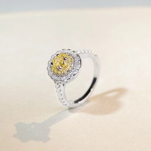 Elegant silver ring featuring a yellow oval gemstone with a double halo of white crystals