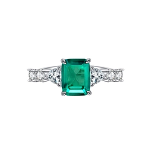 Elegant silver ring featuring a large emerald-cut green stone with side zircon accents