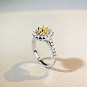 Elegant sterling silver ring featuring a yellow oval zircon with a double halo design