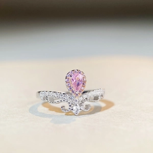 Elegant S925 sterling silver crown ring with a pear-cut pink gemstone and small diamonds